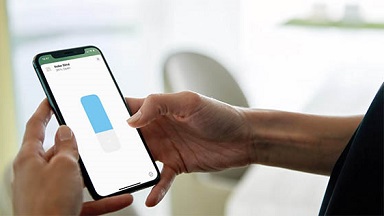 A person controlling smart home via mobile app