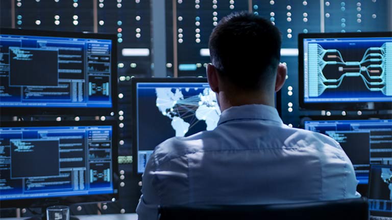 Man multiple computer screens.