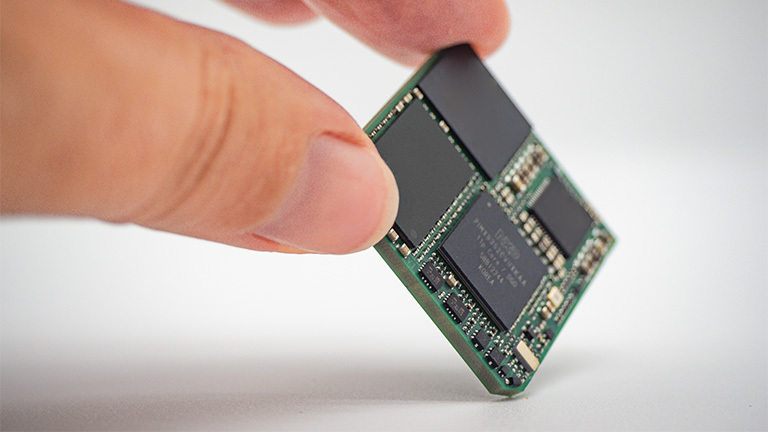person holding a small open standards module