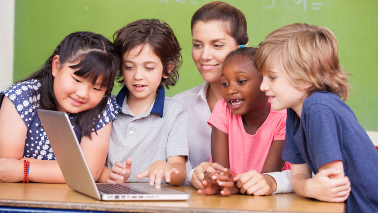 5 kids looking at a laptop
