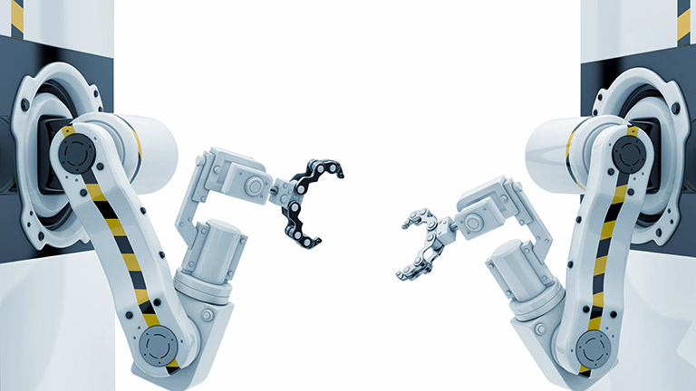 Two robot arms face each other in a clean room