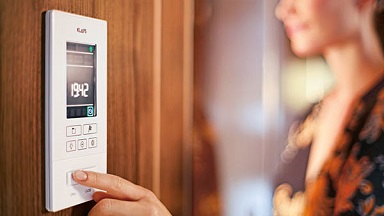 A person controlling sauna temperature