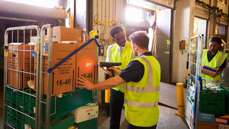 Three collegues working in a warehouse