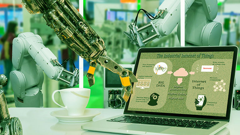 robotic arm using a laptop in a manufacturing environment 