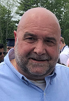 smiling man looking into camera