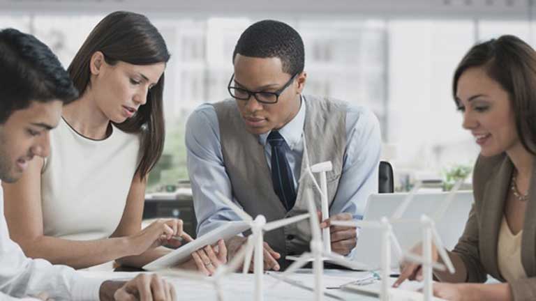 tech workers gathered around table during meeting