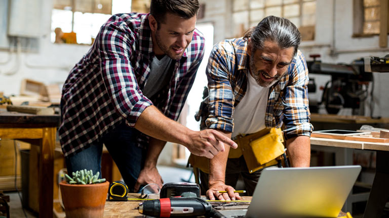 two men looking at laptop