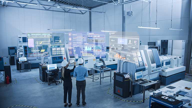 factory showing IoT data on screens above the machines
