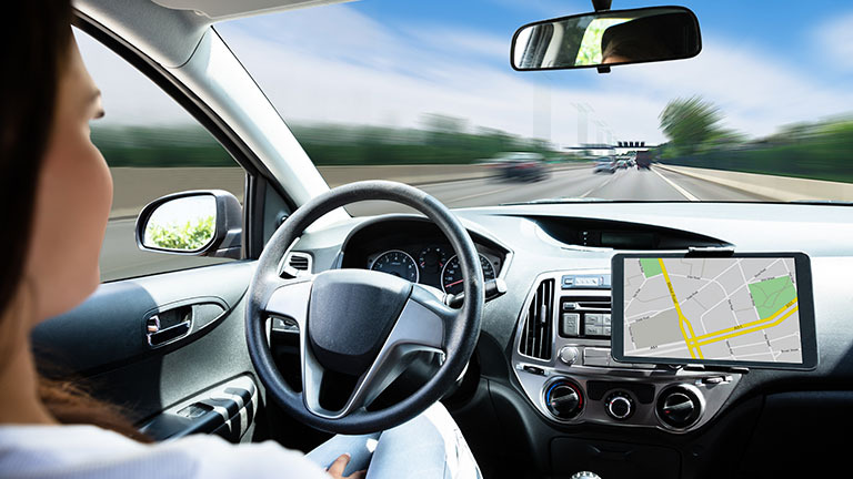 Woman riding in self-driving car.