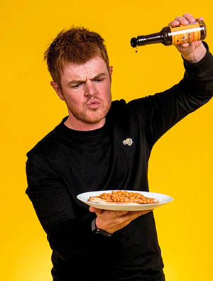 Matt Gibson from SAUCE pouring sauce over the food on a plate