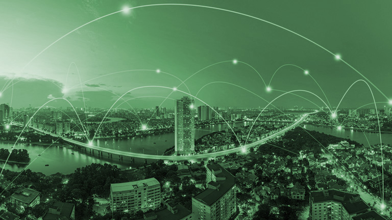 Green-philtered city panorama with nodes connected over the city