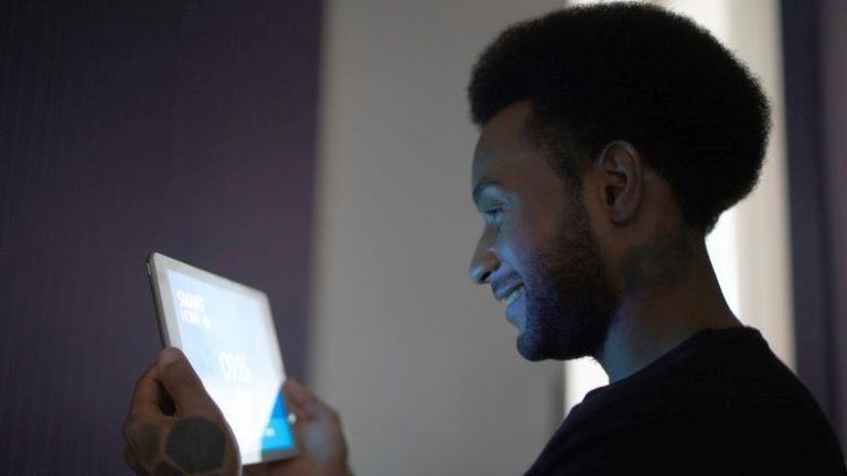 Man looking at a tablet; an example of smart building technology