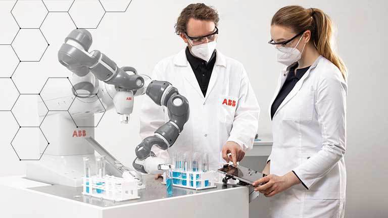 Lab technicians using robotic device