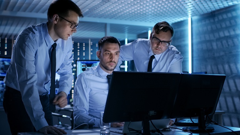 Three employees monitoring supplying process on PC