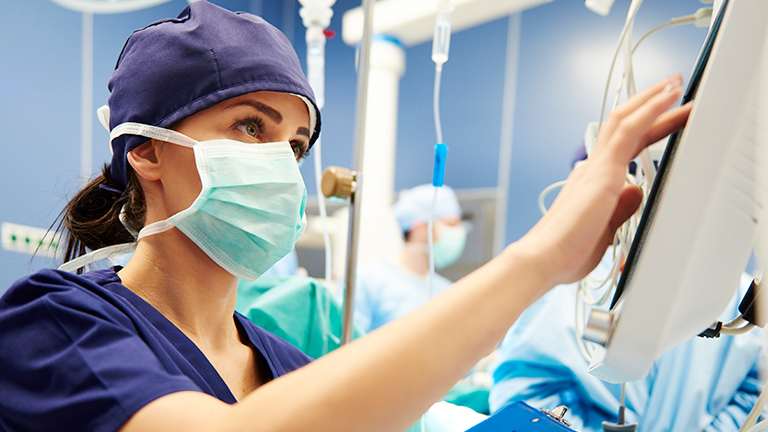 Operating room nurse on health monitor
